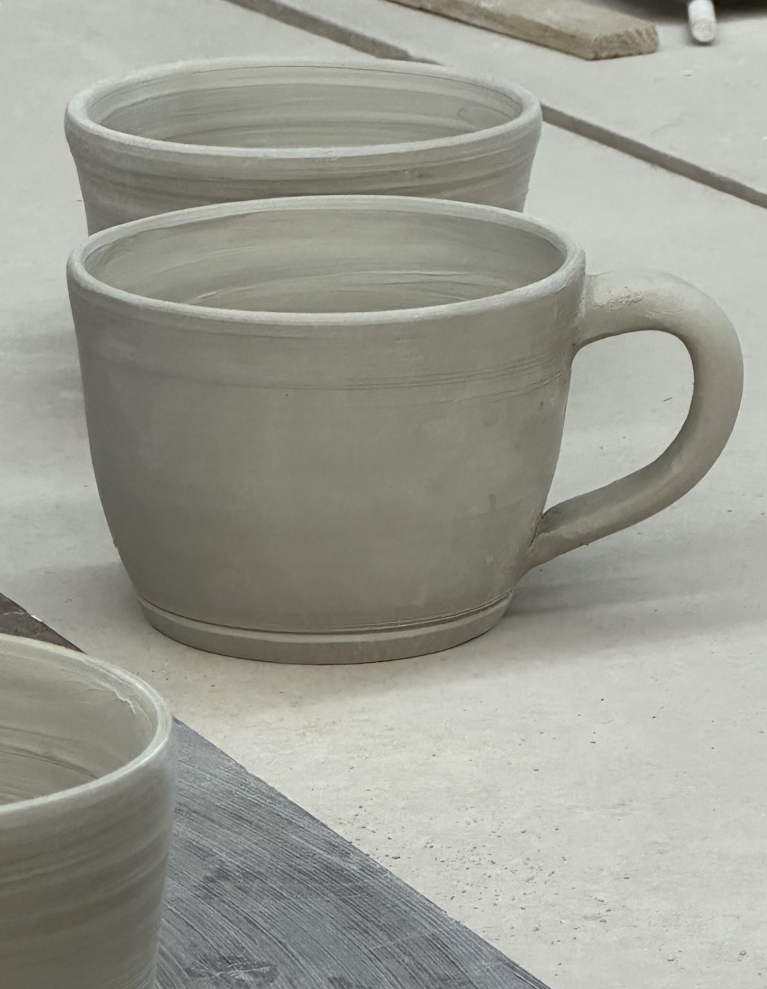 Hand-thrown mugs waiting to be finished